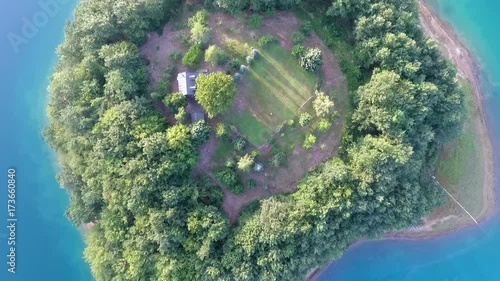 Drone aerial shoot of small island on Ramsko Jezero lake - a tourist destination near Prozor, Bosnia and Herzegovina