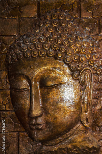 Siddhartha bronze statue. Close up of Buddha beautiful serene face with closed eyes. Best meditation inspiration image or mindfulness background.