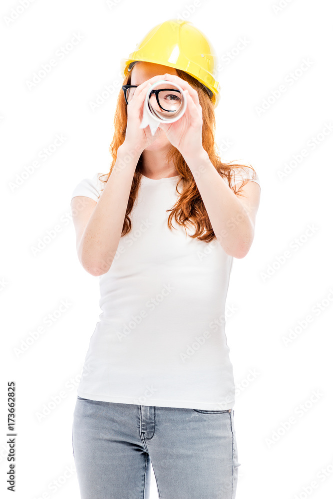 Red-haired girl in yellow helmet with drawings isolated Red-haired girl in yellow helmet with drawings isolated