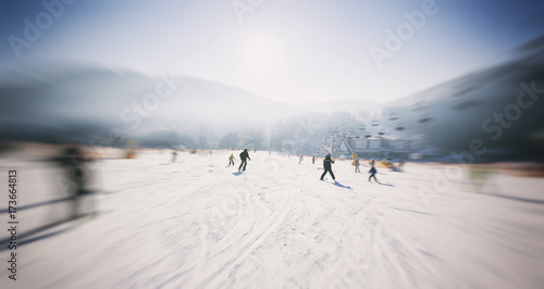 People are skiing in the mountains © SkyLine