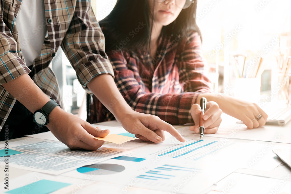 Teen age young business analyzing financial figures denoting the progress in the work,consult concept. Teen age young business analyzing financial figures denoting the progress in the work,consult concept.