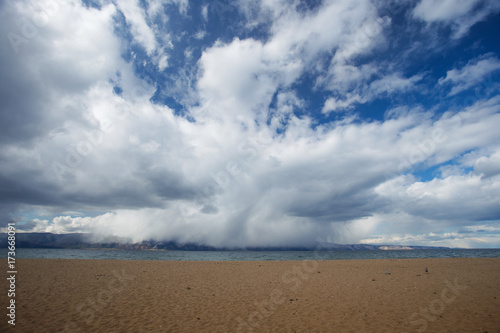 the beach on the lake Baikal in cloudy weather in the summer.