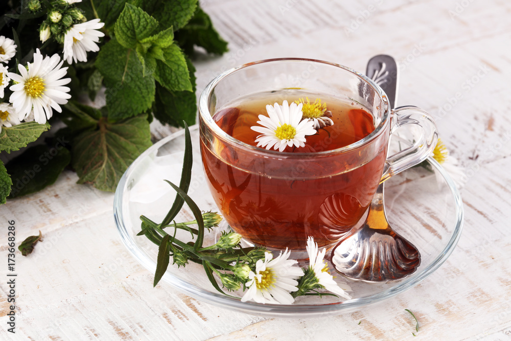 cup of tea with chamomile flowers on rustic background cup of tea with chamomile flowers on rustic background