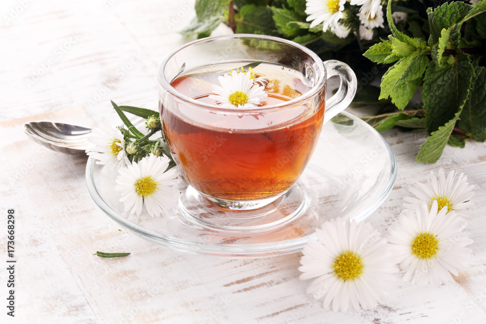 cup of tea with chamomile flowers on rustic background cup of tea with chamomile flowers on rustic background