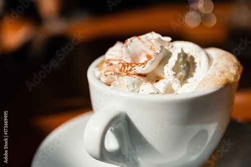 Close-Up Of Delicious Cappuccino With Fresh Whipped Cream And Cinnamon On Top