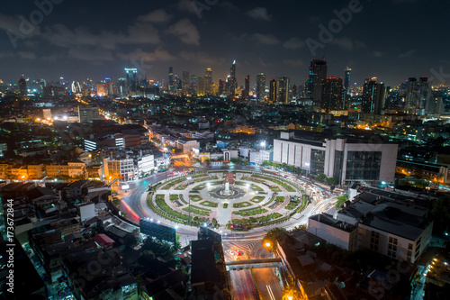 The light on the road roundabout at night and the city in Bangkok.