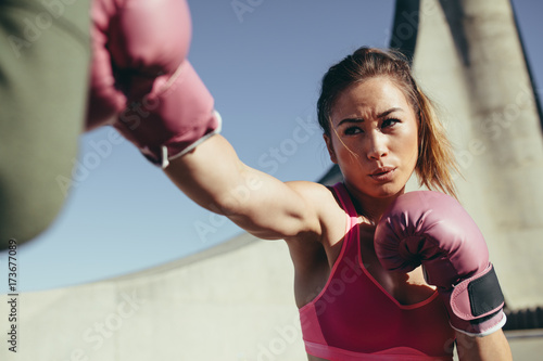Sportswoman practicing boxing outdoors © Jacob Lund