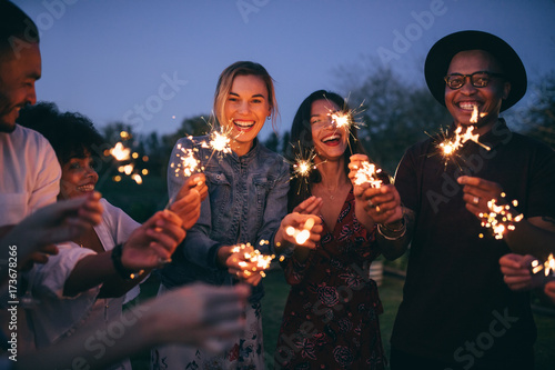 Group of friends enjoying out with sparklers photo