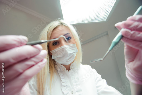 Attractive female dentist working in modern dental office