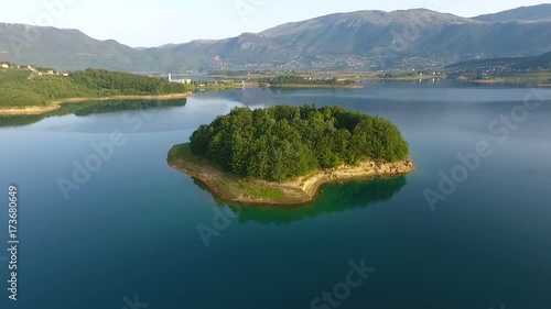 Drone aerial shoot of small island on Ramsko Jezero lake - a tourist destination near Prozor, Bosnia and Herzegovina