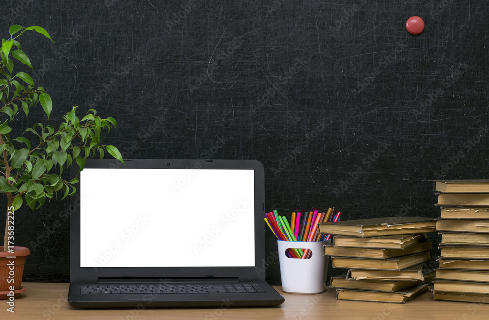 Teacher or student desk table. Education background. Education mockup  concept. Laptop with blank screen, green plant tree, stacked books and  colour pencils on blackboard (chalkboard) background. Stock Photo | Adobe  Stock