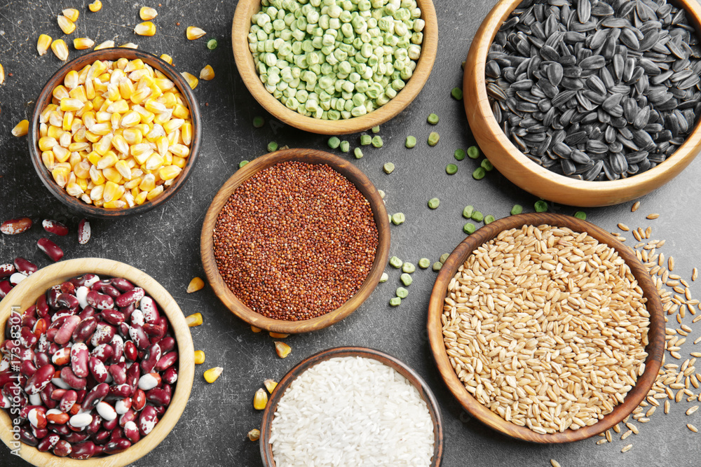 Bowls with different grains on dark background Bowls with different grains on dark background