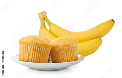 Fresh bananas and muffins on plate, isolated on white