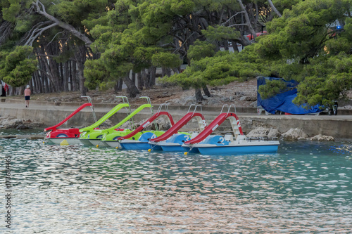 parked pedal boats with slides at sea shore
