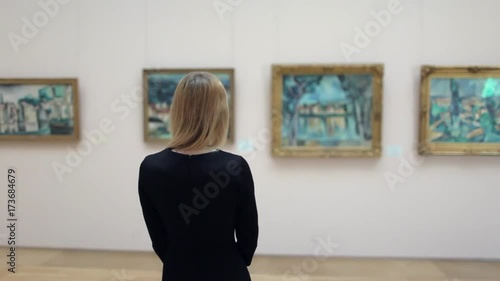 Beautiful Woman Looking at a Picture in a Museum