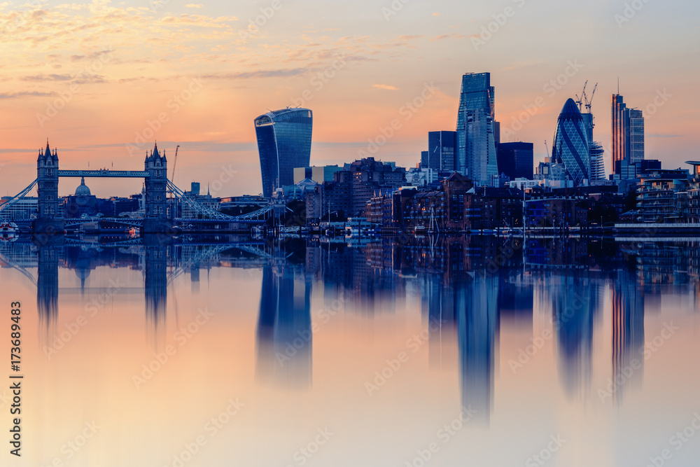 Cityscape of London at sunset with reflection from river Thames