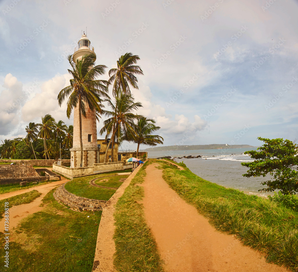 Lighthouse between palm trees in Fort Galle Sri-Lanka