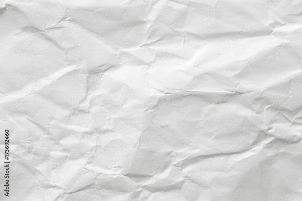 The texture of white paper with kinks. Background of a crumpled surface. The texture of white paper with kinks. Background of a crumpled surface.