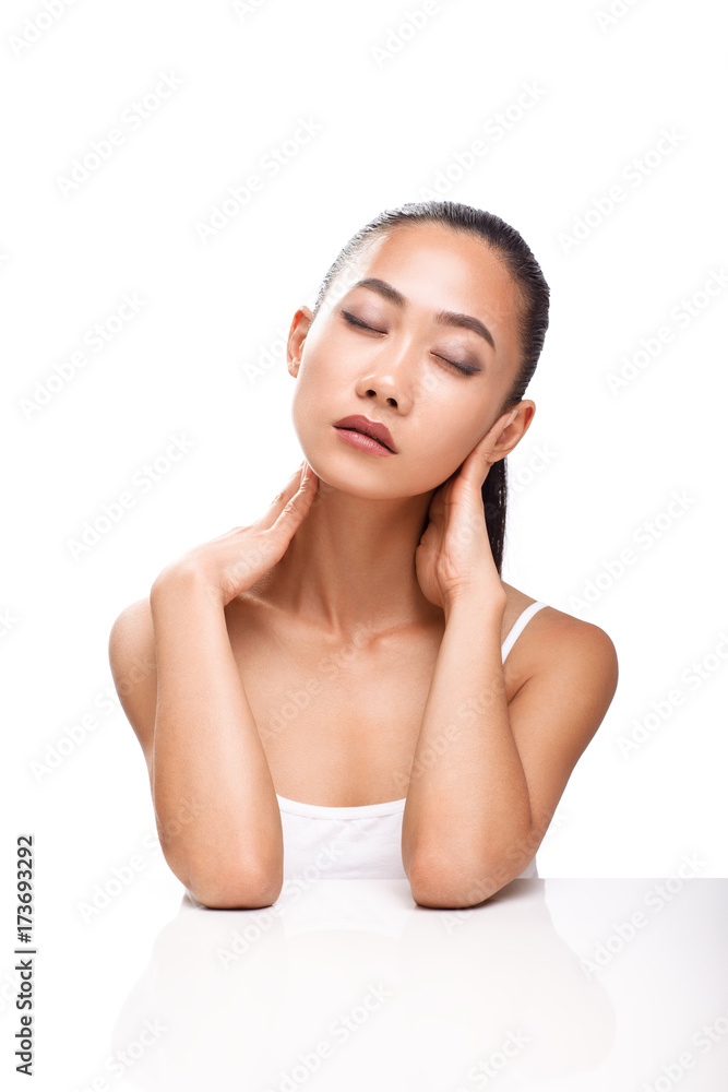 Beautiful young Asian woman with closed eyes and calm face Beautiful young Asian woman with closed eyes and calm face