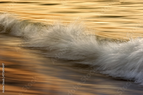 Waves on the ocean captured with a slow shutter speed photo