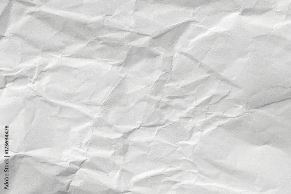 The texture of white paper with kinks. Background of a crumpled surface. The texture of white paper with kinks. Background of a crumpled surface.