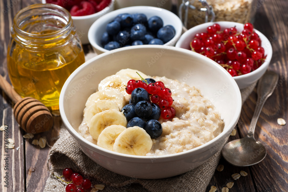 homemade oatmeal with berries on wooden background homemade oatmeal with berries on wooden background