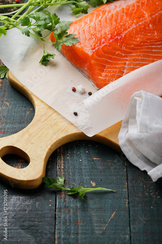 Raw salmon steak on cutting board