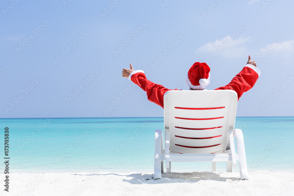 Santa Claus relaxing on sun bed, Christmas card Santa Claus relaxing on sun bed, Christmas card