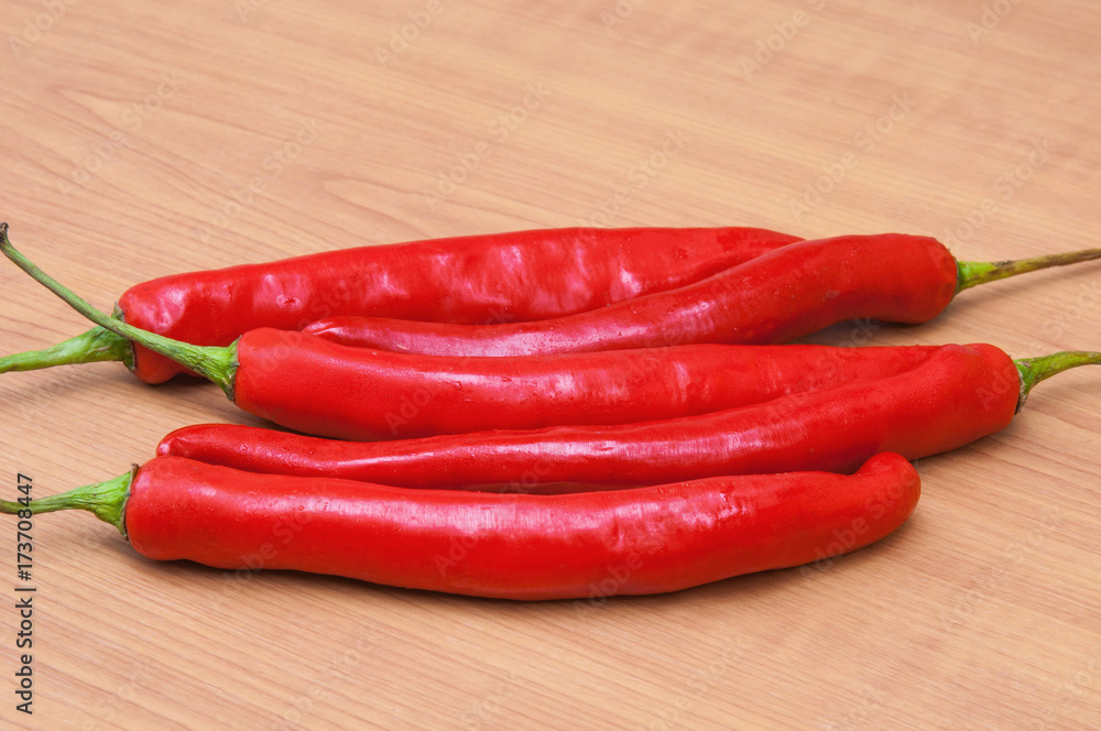 fresh red chilies on a wooden background