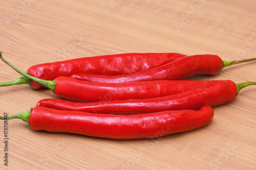 fresh red chilies on a wooden background