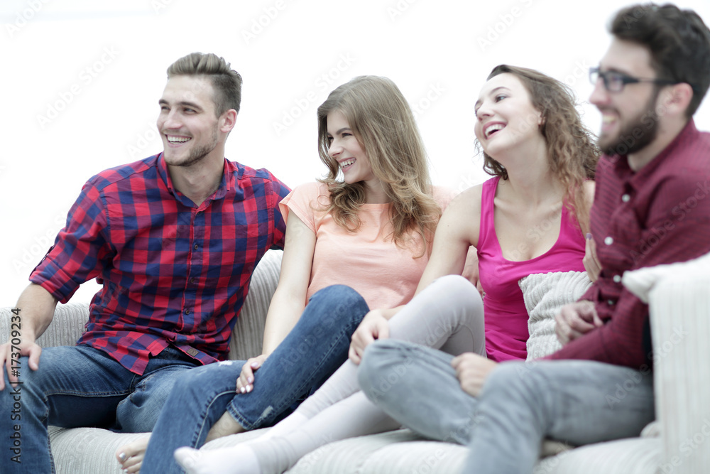 group of cheerful friends sitting on the couch