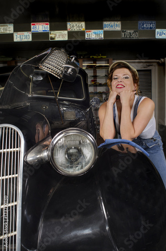 girl leaned on the fender of a black vintage car © valeie