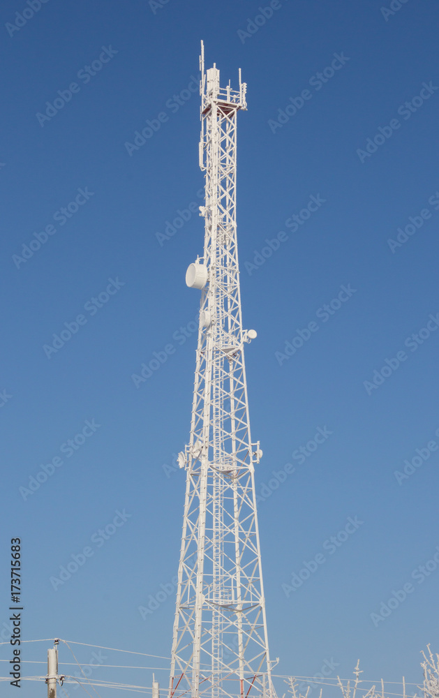 Telecom broadcasting tower network under blue sky Telecom broadcasting tower network under blue sky