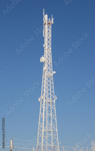 Telecom broadcasting tower network under blue sky