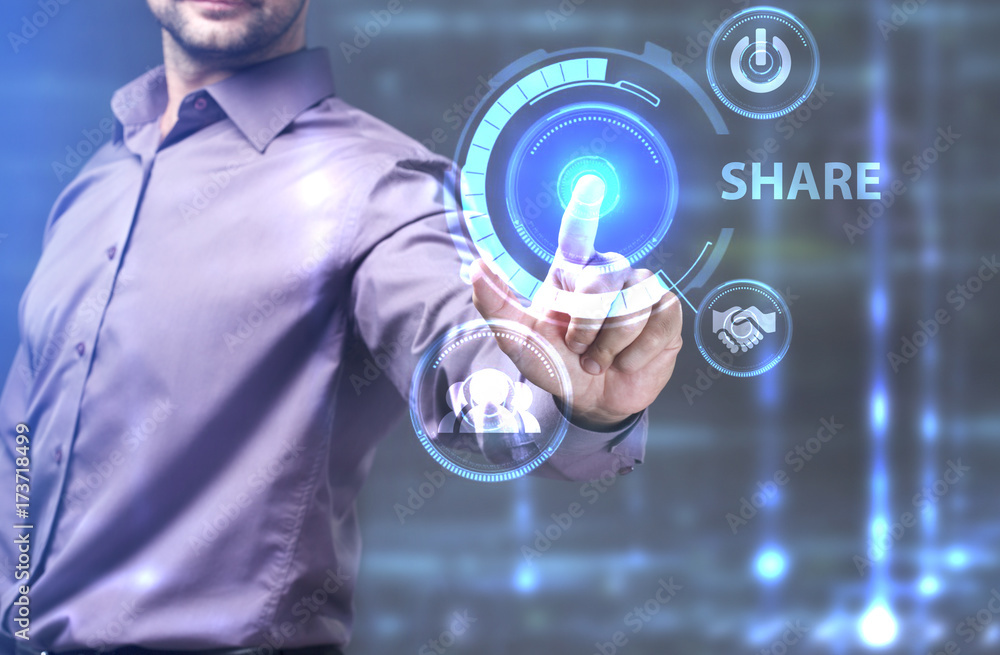 The concept of business, technology, the Internet and the network. A young entrepreneur working on a virtual screen of the future and sees the inscription: Share The concept of business, technology, the Internet and the network. A young entrepreneur working on a virtual screen of the future and sees the inscription: Share