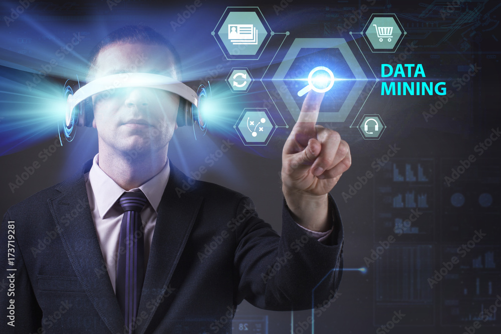 Business, Technology, Internet and network concept. Young businessman working in virtual reality glasses sees the inscription: Data mining Business, Technology, Internet and network concept. Young businessman working in virtual reality glasses sees the inscription: Data mining
