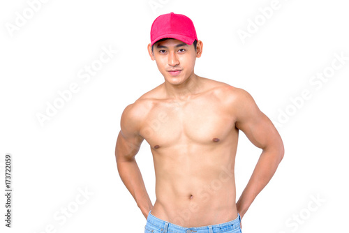 Handsome muscular young Asian man shirtless in blue jean and red cap  isolated on white background