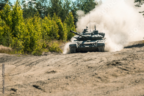 Main battle tank are going to dust on the ground for military exercises photo