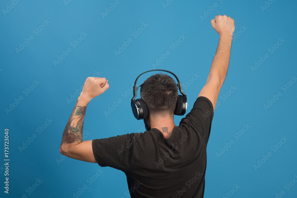 Naklejka premium Relax and music concept. Dj with scorpio tattoo wears headphones