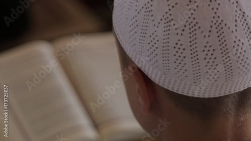 rear view of one boy learning the Quran.