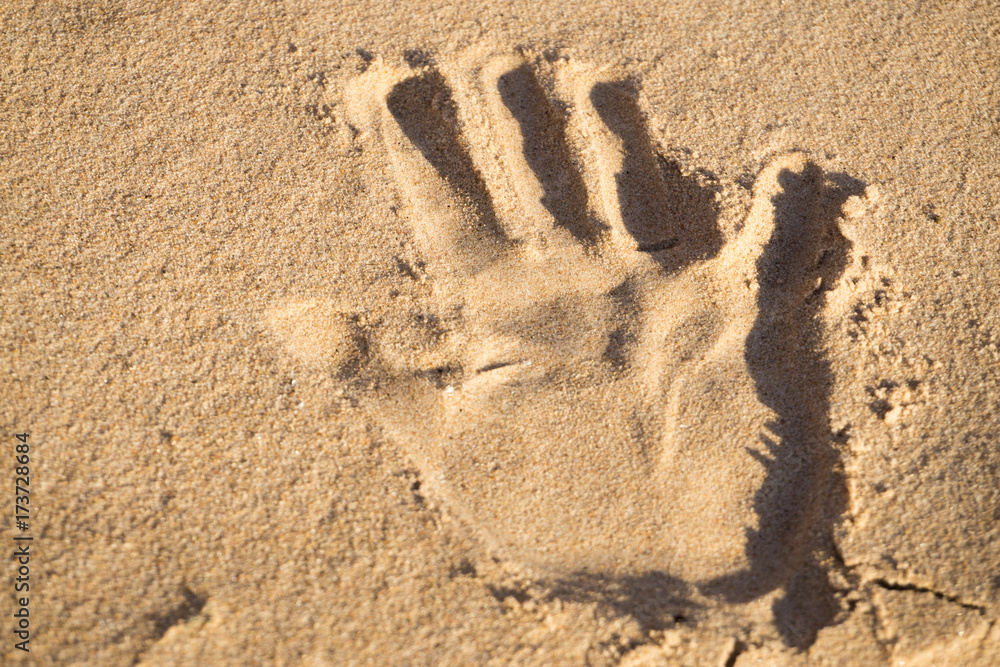 Handprints in the sand on the beach of the Baltic Sea in summer: summer is almost gone, waiting for autumn. Handprints in the sand on the beach of the Baltic Sea in summer: summer is almost gone, waiting for autumn.