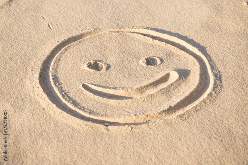 Fototapeta Naklejka Na Ścianę i Meble -  Prints of emoji smile in the sand on the beach of the Baltic Sea in summer: summer is almost gone, waiting for autumn.