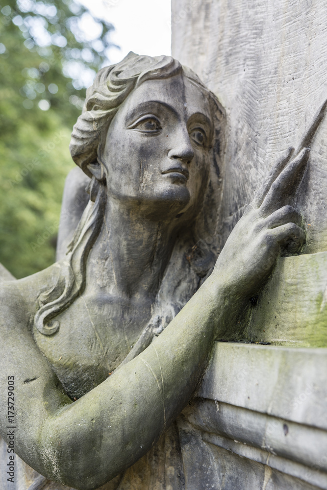 Statue of an angel woman in a cemetery.