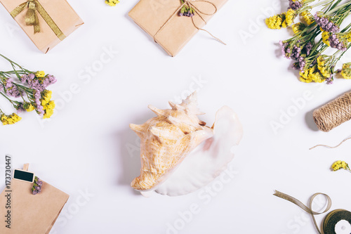 Top view holiday decorations, large seashell and flowers