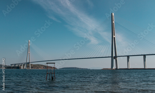 Magnificent view of the cable-stayed bridge from the mainland to the island across the strait, beautiful sea background