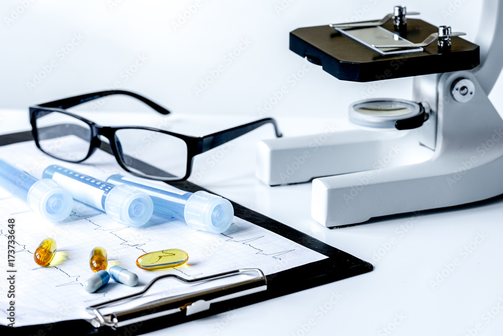 doctors desk with microscope and test tubes doctors desk with microscope and test tubes