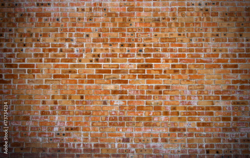 Texture of old red brick wall surface with cement and concrete seams