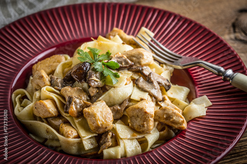 Tagliatelle pasta with forest mushrooms and chicken.