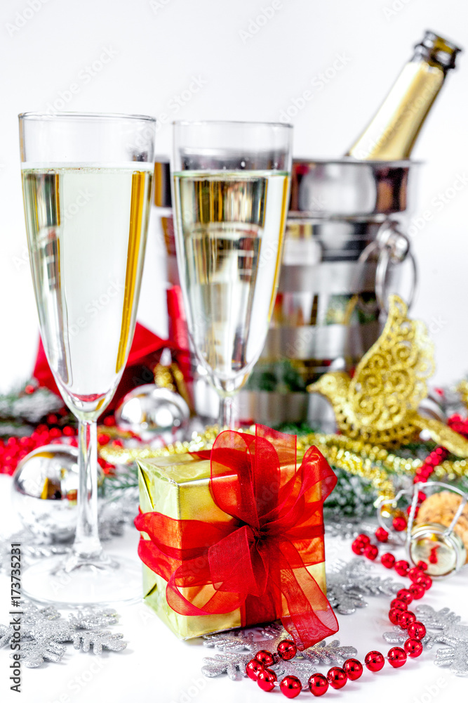 glasses of champagne and Christmas ornaments on white background glasses of champagne and Christmas ornaments on white background