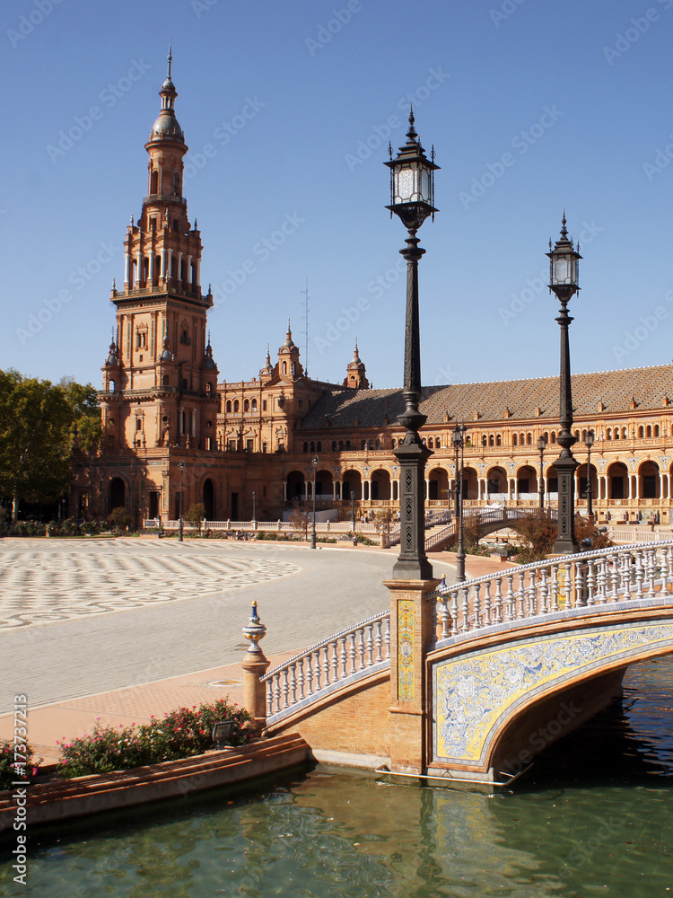 Bridge with lanterns over the boat canal leading to the palace on Spain Square (Plaza de Espana) in Seville (Sevilla), Spain. Example of Moorish and Renaissance revival.